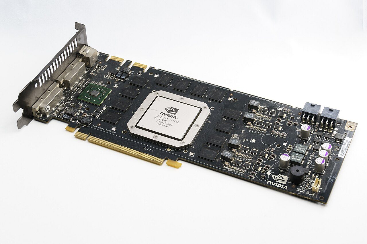 A GeForce 8800 GTX circuit board with its cooler removed: a large square chip under a silver heat spreader marked NVIDIA in the middle, memory chips around it, and a smaller chip near the display connectors