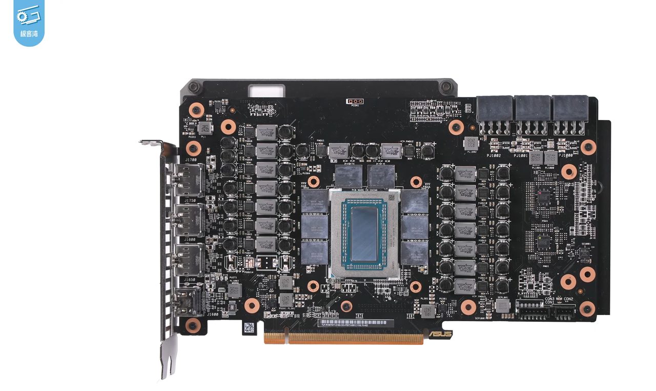 The circuit board of an ASUS Radeon RX 9070 XT with its cooler removed: the Navi 48 die in a metal frame at the centre, eight grey memory chips around it, and columns of power components on each side