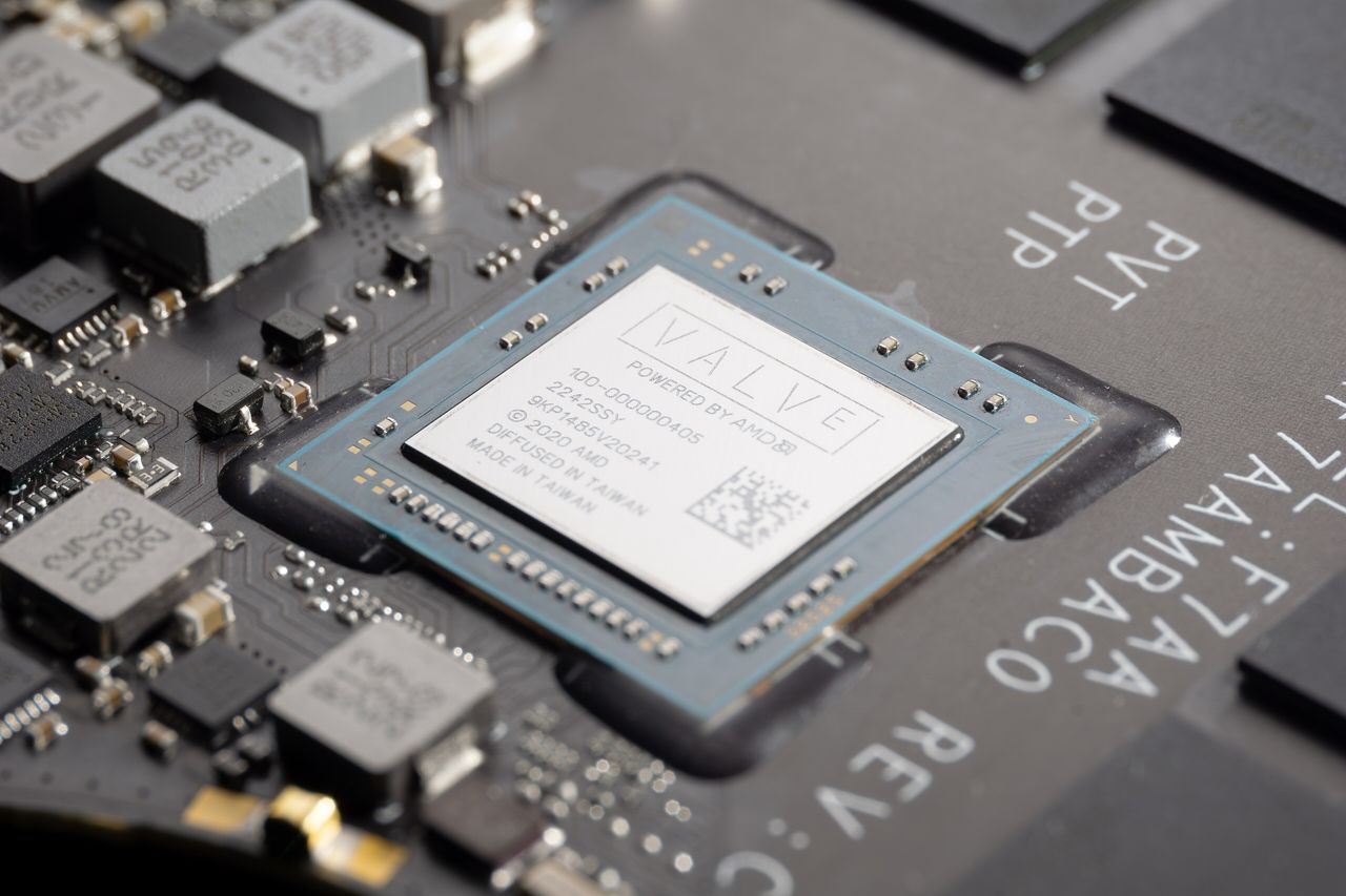 The Steam Deck's AMD processor on its black circuit board: a small square package with a silver lid printed with the Valve logo, surrounded by small power components